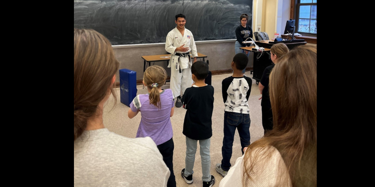 Rickyjon Balgenorth teaching karate to elementary school students with the Purdue Karate Club